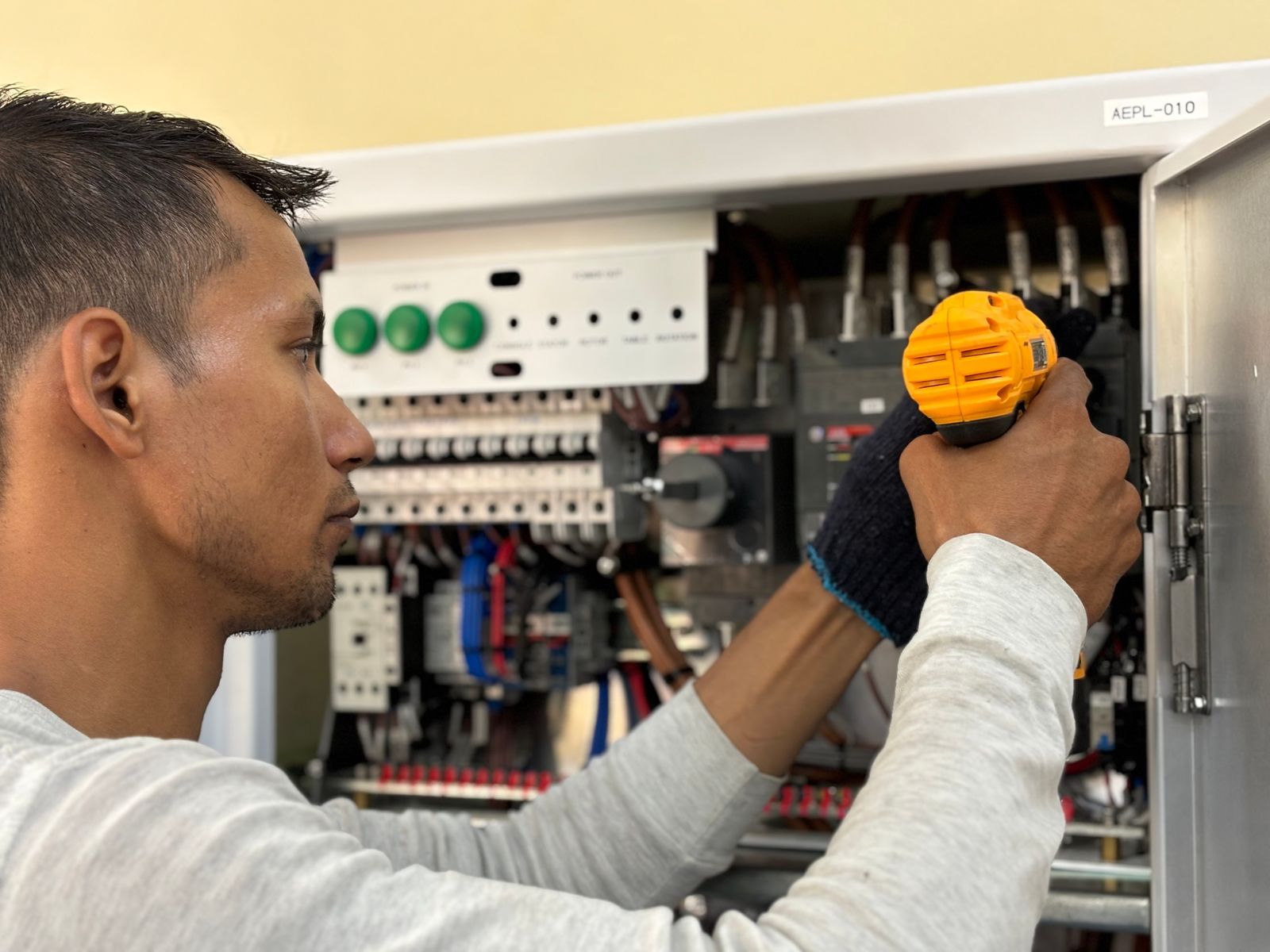 A Circle City electrician working on an electrical control panel during an Indianapolis service call.
